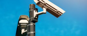 CCTV camera, modern era anti-terrorist electronic surveillance security cameras against blue sky that symbolizes freedom
