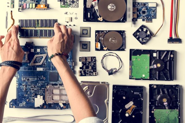 Hands holding a computer component part